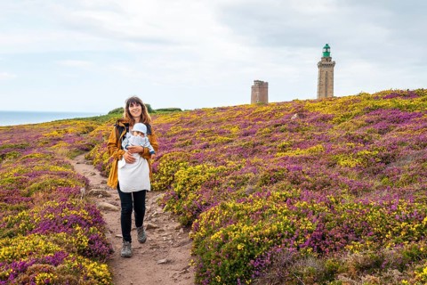 A mother next to the flowers in summer in Phare Du Cap Frehel
