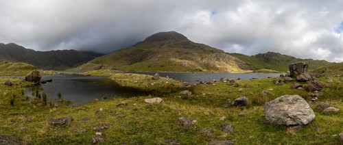 Lake Llyn Llydaw with Mount Snowdon behind clouds in late summer