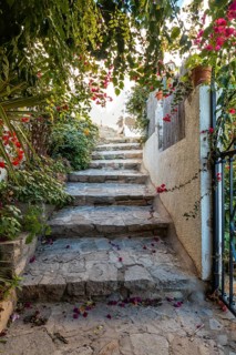 I walk between houses in Mojacar with white houses on top of the mountain. Costa Blanca in the Mediterranean Sea