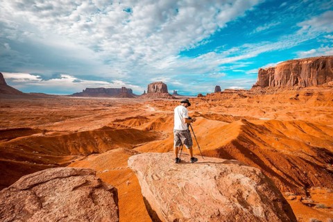A European photographer at John Ford's Point in Monument Valley preparing a panor. Utah