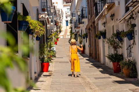 A tourist in Mijas visiting the white houses and charming town and the slopes in Malaga. Andalusia