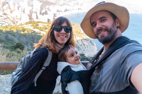 A family looking at the city of Calpe from the path of the Penon de Ifach Natural Park