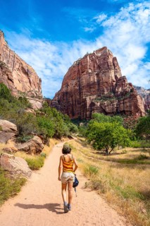 A young woman starting the trekking climb of the Angels Landing Trail in Zion National Park