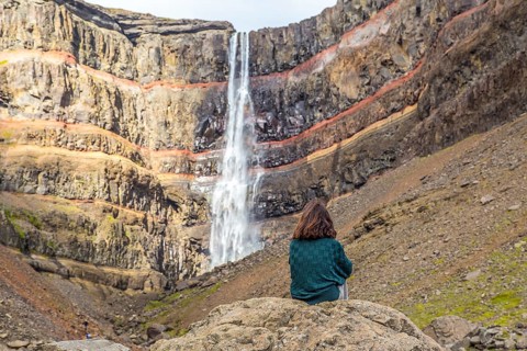A young girl sitting in one of the wonders of Iceland