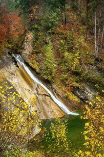Schleierfaelle at the entrance to the Starzlachklamm gorge in autumn. Trees in autumn foliage. Long exposure. Allgaeu