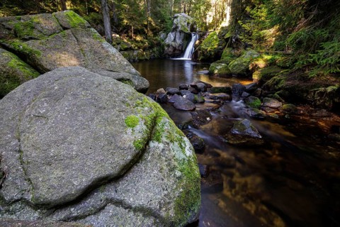 Waterfall in autumn forest with rocks