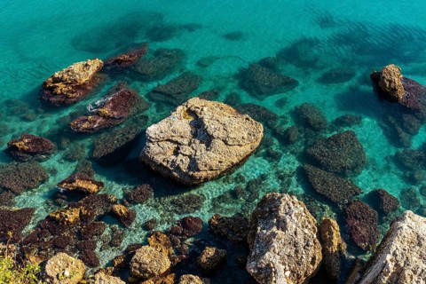 Detail of the sea and rocks on Calahonda beach in the town of Nerja