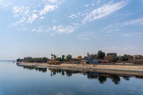 Traditional Egyptian villages on the bank of the river Nile. Views sailing on the cruise on the river Nile from Luxor to Aswer