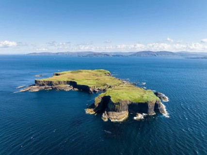 Aerial view of the uninhabited rocky island of Staffa with the prominent basalt columns and Fingal's Cave
