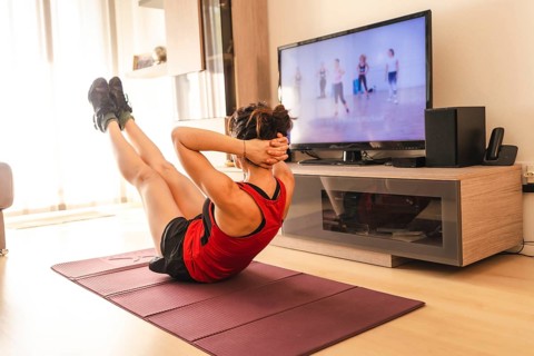 A young woman doing sports in her living room. Sport in the quarantine at home