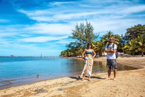 Two young men on the beach of Sandy Bay on Roatan Island. Honduras