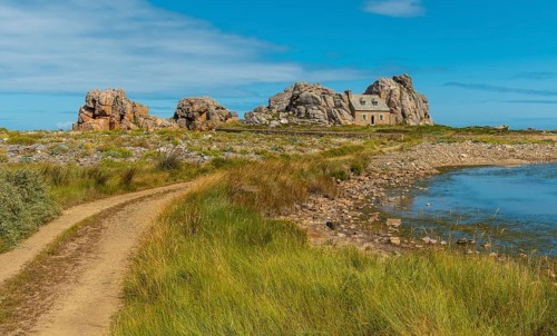 Path to the house among rocks by the sea