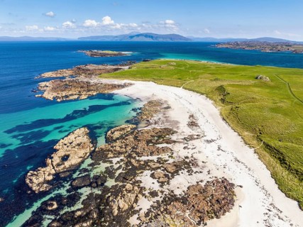 Aerial view of Traigh An T-Suidhe sandy beach on the north side of the Isle of Iona