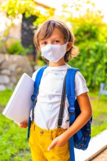 Caucasian child with face mask ready for back to school. New normality