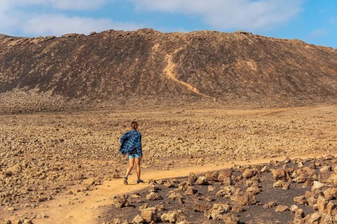 A young woman on the trail to the Crater of the Calderon Hondo volcano near Corralejo