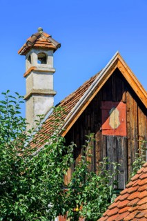 Pointed gable with wooden facade and brick chimney in the Farm Museum