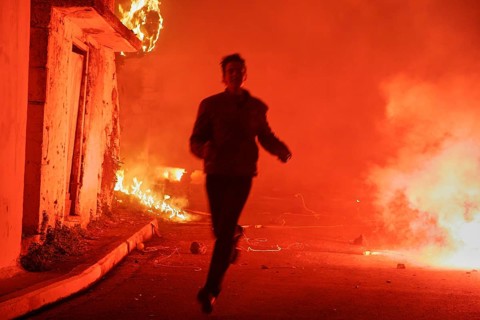 Young man runs through pyrotechnics
