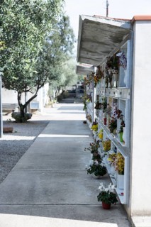 Wall with decorated urns graves in a cemetery in Sardinia
