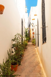 Road between houses in Mojacar with white houses on top of the mountain. Costa Blanca in the Mediterranean Sea