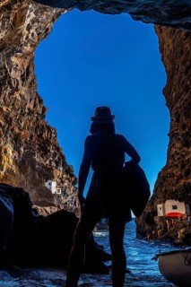 A young woman inside the cave of the town of Poris de Candelaria on the north-west coast of the island of La Palma
