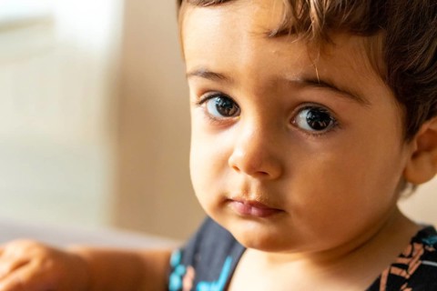 Portrait of a one year old Caucasian boy looking at the camera