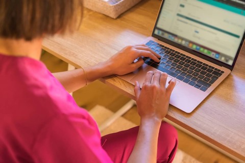 Closeup view of nutritionist doctor working and writing diet plan on computer