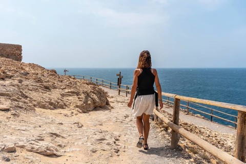 A young tourist walking on the path in the Cuevas de Ajuy