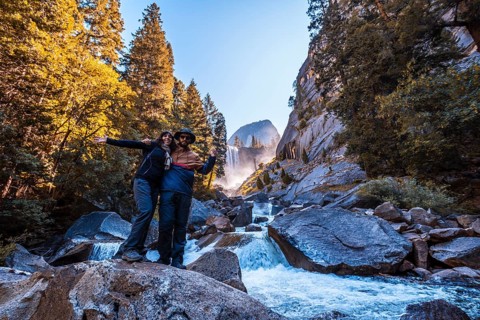 A couple in Vernal Falls waterfall of Yosemite National Park
