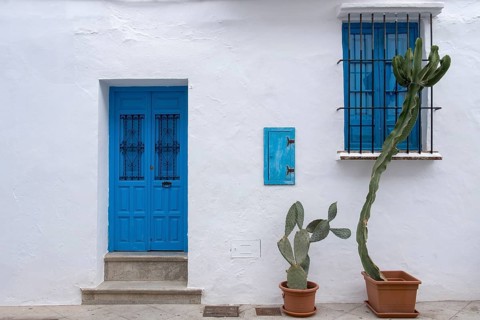 House facade with blue front door and window