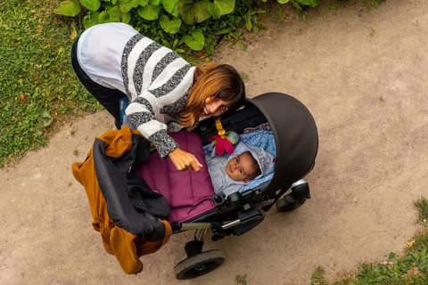 A mother with her baby in the gardens of the Abbaye de Beauport in the village of Paimpol