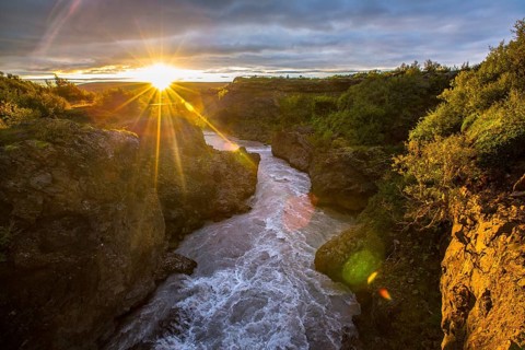 Sunset seen from the wooden bridge of the Barnafoss river