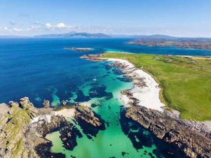 Aerial view of Traigh An T-Suidhe sandy beach on the north side of the Isle of Iona