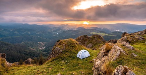 Wild camping on the top of a mountain at sunset