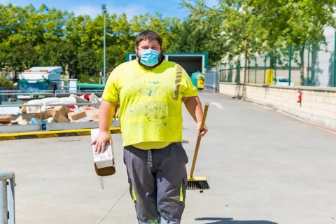 Worker in a recycling factory or clean point and garbage with a face mask and with security protections