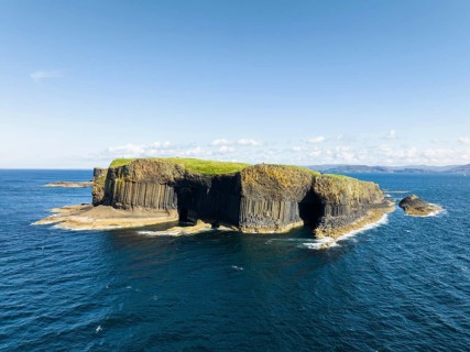 Aerial view of the uninhabited rocky island of Staffa with the prominent basalt columns and Fingal's Cave