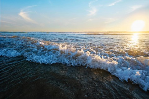 Atlantic ocean sunset with surging waves at Fonte da Telha beach