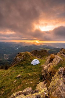 Wild camping on the top of a mountain at sunset