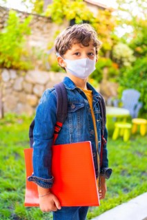 Caucasian child with face mask ready for back to school. New normality
