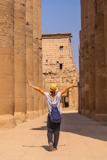 A young tourist wearing a hat visiting the Egyptian Temple of Luxor. Egypt