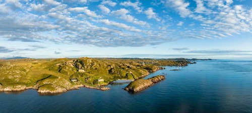 Aerial panorama of the coastline of the Ross of Mull peninsula and the fishing village of Fionnphort on the right
