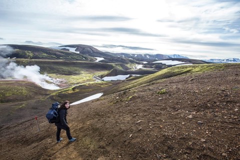Woman in pools of boiling water on the 54 km trek from Landmannalaugar