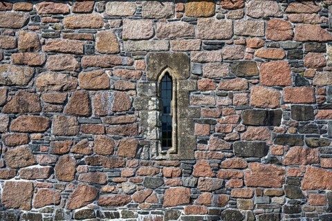Ross of Mull granite and basalt house wall with a narrow window
