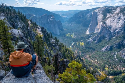 A young winged seated Taft point looking at Yosemite National Park and El Capitan. United States
