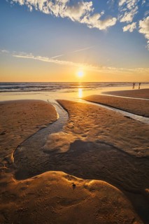 Atlantic ocean sunset with surging waves at Fonte da Telha beach