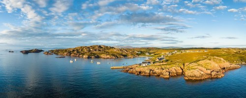 Aerial panorama of the coastline of the Ross of Mull peninsula with the fishing village of Fionnphort