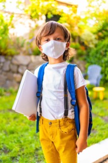 Caucasian child with face mask ready for back to school. New normality