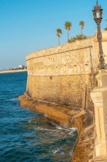 Walls and sea coast of the Baluarte de la Candelaria in the city of Cadiz. Andalusia