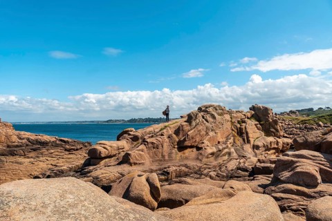 A young woman by the sea on the coast next to Lighthouse Mean Ruz