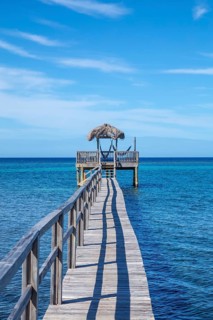 Wooden footbridge over the Caribbean Sea on Roatan Island. Honduras