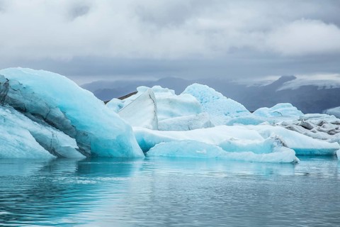 Beautiful icebergs on Jokulsarlon Ice Lake in the golden circle of southern Iceland on a cold August morning